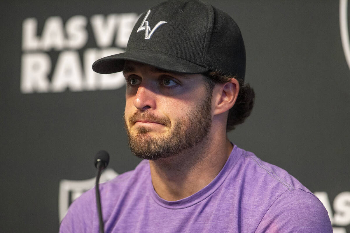 Raiders quarterback Derek Carr reacts while speaking to media about former teammate Henry Ruggs ...