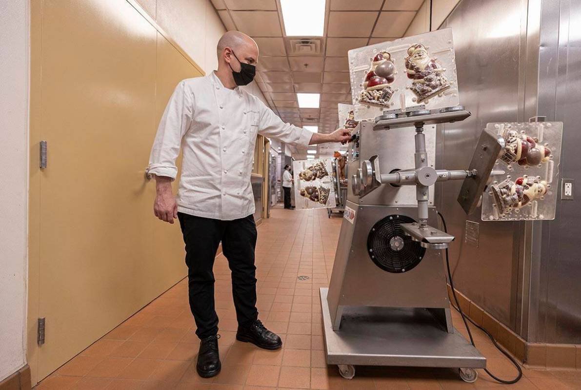Executive pastry chef Mathieu Lavallee runs a pastry machine that evenly applies chocolate to S ...