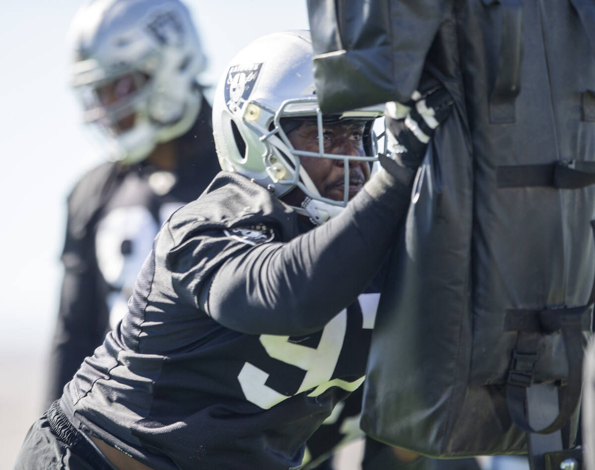 Raiders defensive tackle Damion Square (97) hits the tackle sled during a practice session at t ...