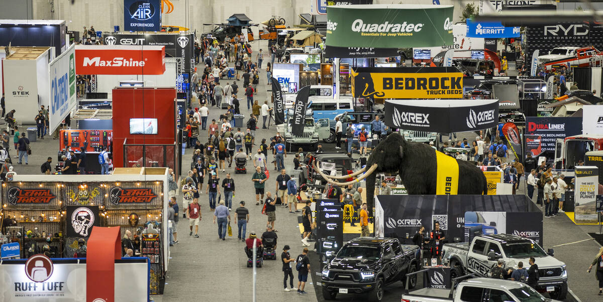 Attendees walk about the West Hall during SEMA at the Las Vegas Convention Center on Friday, No ...