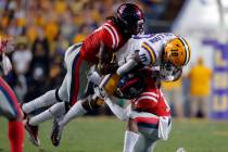 LSU wide receiver Stephen Sullivan (10) is stopped by Mississippi linebacker Kevontae' Ruggs, l ...