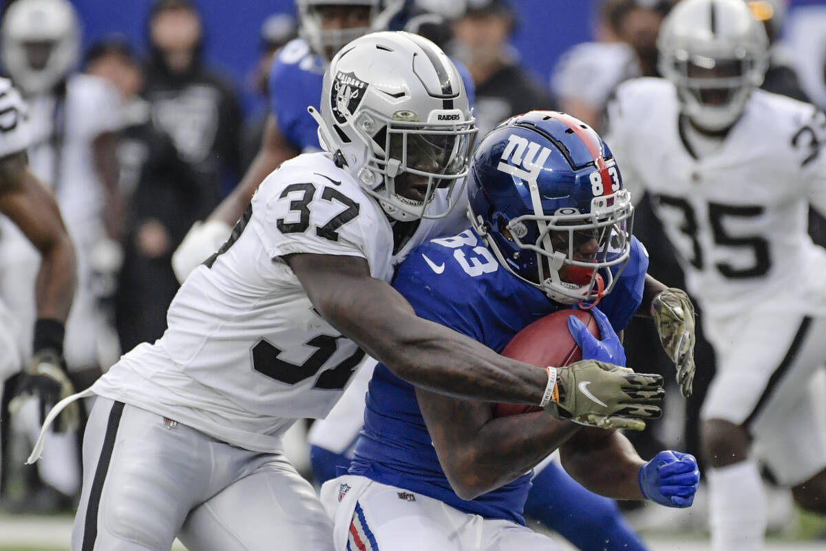 Las Vegas Raiders' Tyree Gillespie (37) tackles New York Giants' Pharoh Cooper (83) during the ...