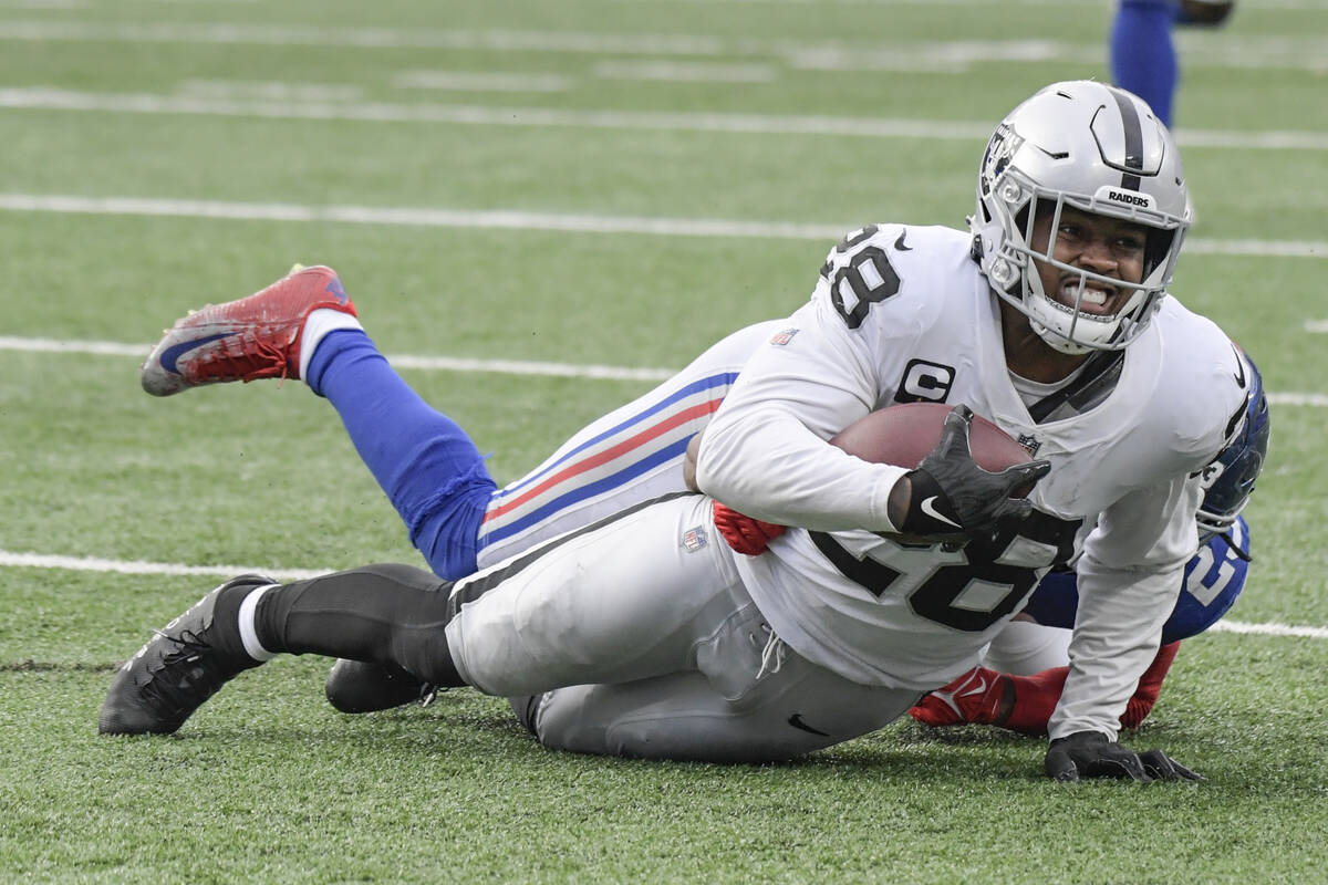 New York Giants' Logan Ryan (23) tackles Las Vegas Raiders' Josh Jacobs (28) during the second ...