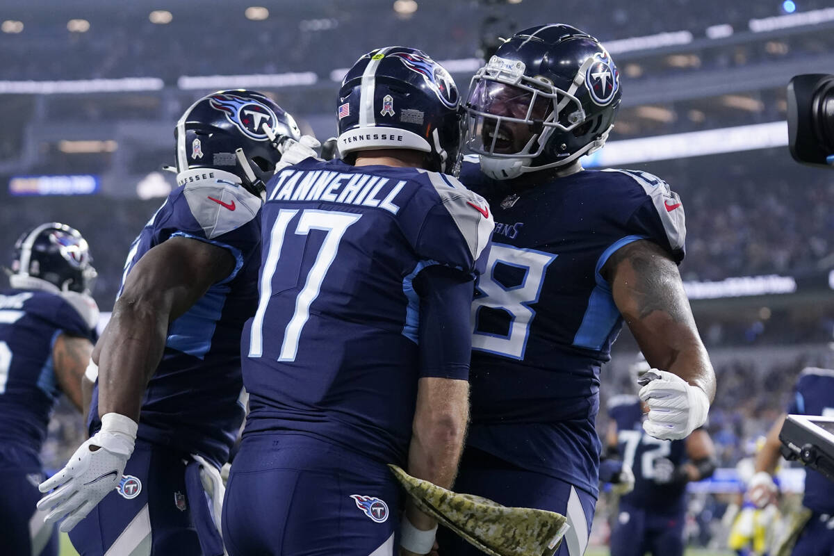 Tennessee Titans quarterback Ryan Tannehill, center, celebrates with teammate running back Adri ...