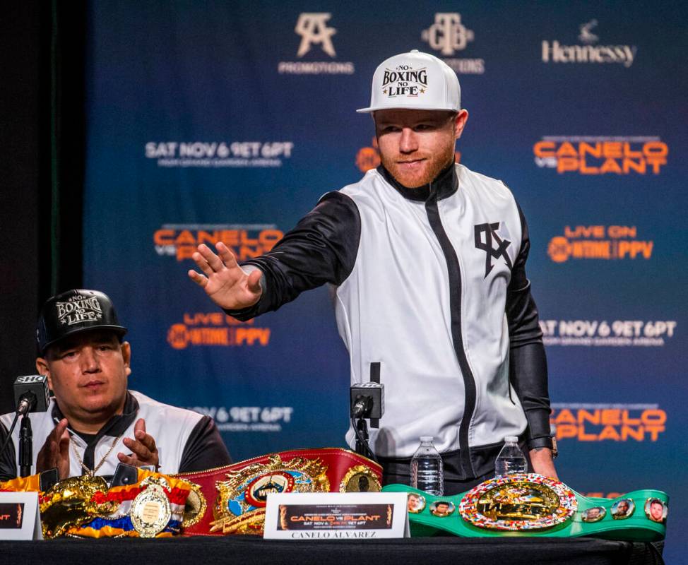 Boxer Canelo Alvarez waves to the crowd as he rises to make some comments during the final pres ...