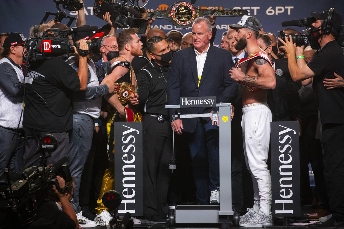 Canelo Álvarez, left, and Caleb Plant pose during a weigh-in event in Las Vegas, Friday, N ...