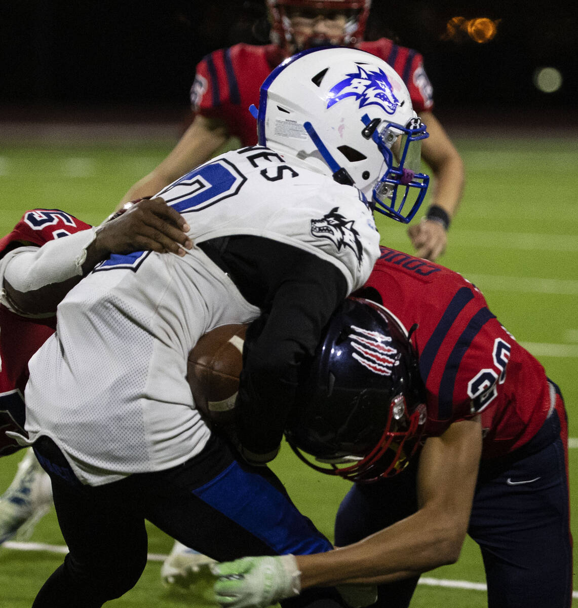 Coronado High center back Preston Mcqueen (20) tackles Basic wide receiver Treyson Redd (12) du ...