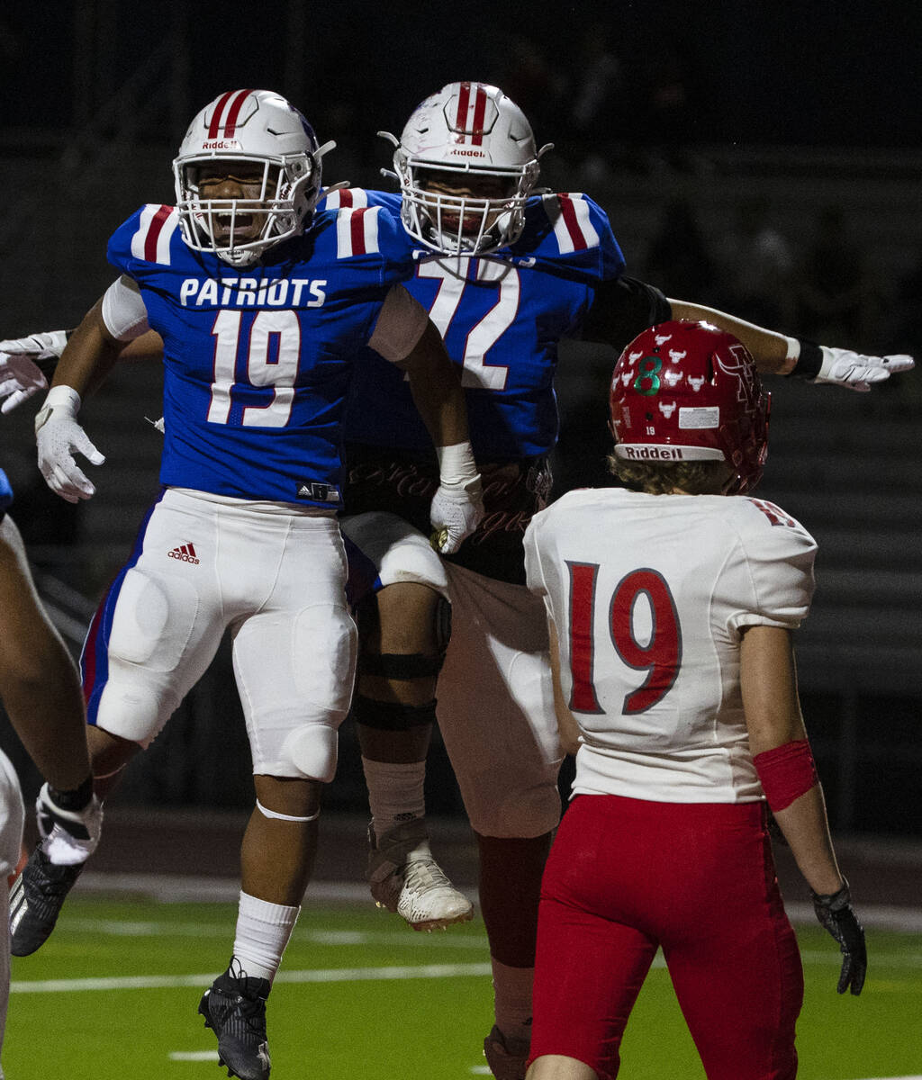 Liberty High halfback Isaiah Lauofo (19) celebrates his touchdown with teammate Jacob Maiava as ...