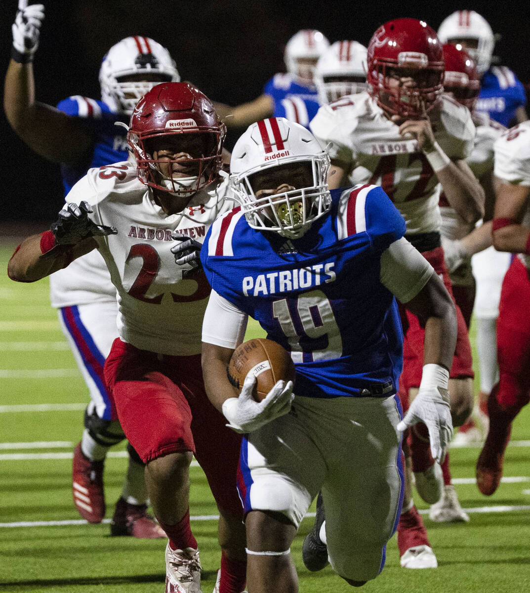 Liberty High halfback Isaiah Lauofo (19) runs past for a touchdown Arbor View running back Toa ...