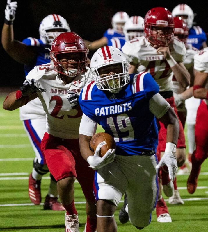 Liberty High halfback Isaiah Lauofo (19) runs past for a touchdown Arbor View running back Toa ...