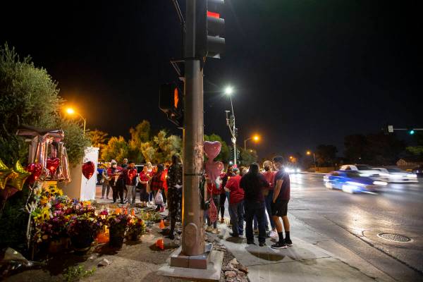 People attend a vigil for Tina Tintor and her dog Max at a memorial on Rainbow Boulevard and Sp ...