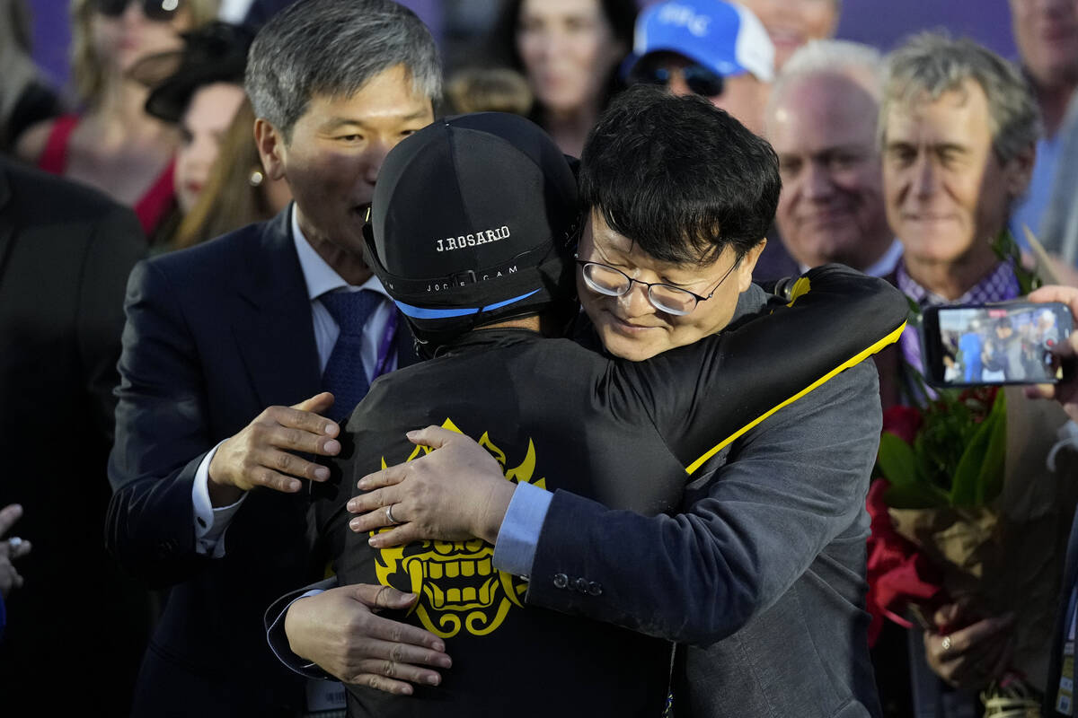 Joel Rosario, center, is congratulated by Lee Jinwoo, senior manager from Korea Racing Authorit ...