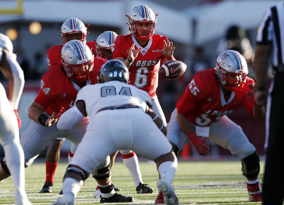 New Mexico quarterback Isaiah Chavez (6) reaches for the snap during the first half of the team ...