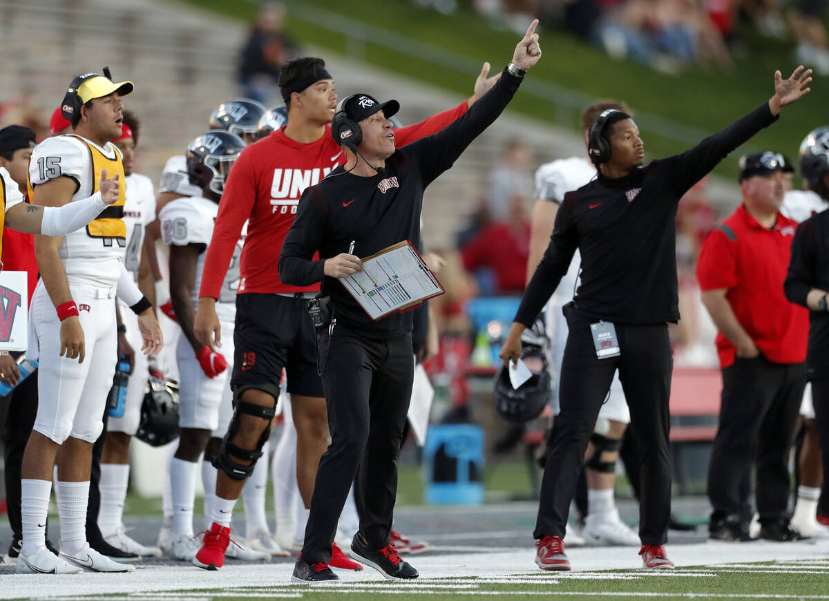 UNLV coach Marcus Arroyo, front left, gestures to players during the first half of an NCAA coll ...