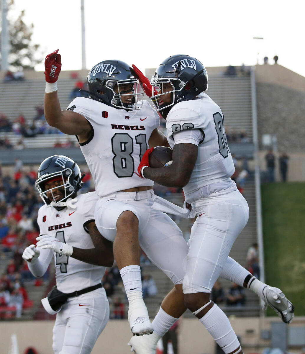 UNLV wide receiver Marcus Phillips Jr. (86) celebrates with tight end Kue Olotoa (81) after sco ...