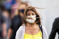 People brave high winds on the Strip on Monday, Oct. 11, 2021, in Las Vegas. Southerly winds ma ...