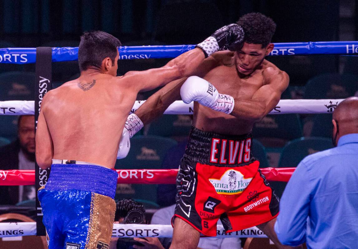 Juan Pablo Romero, left, connects with a punch on Elvis Rodriguez in the first round during the ...