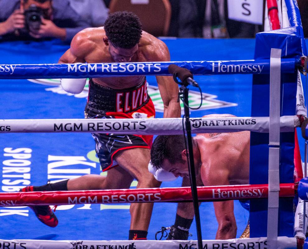 Elvis Rodriguez, left, sends Juan Pablo Romero to the canvas in the fourth round during their s ...