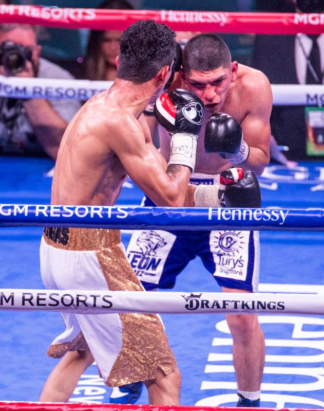Rey Vargas sends ascot to the head of Leonardo Baez in the 7th round during their super bantamw ...