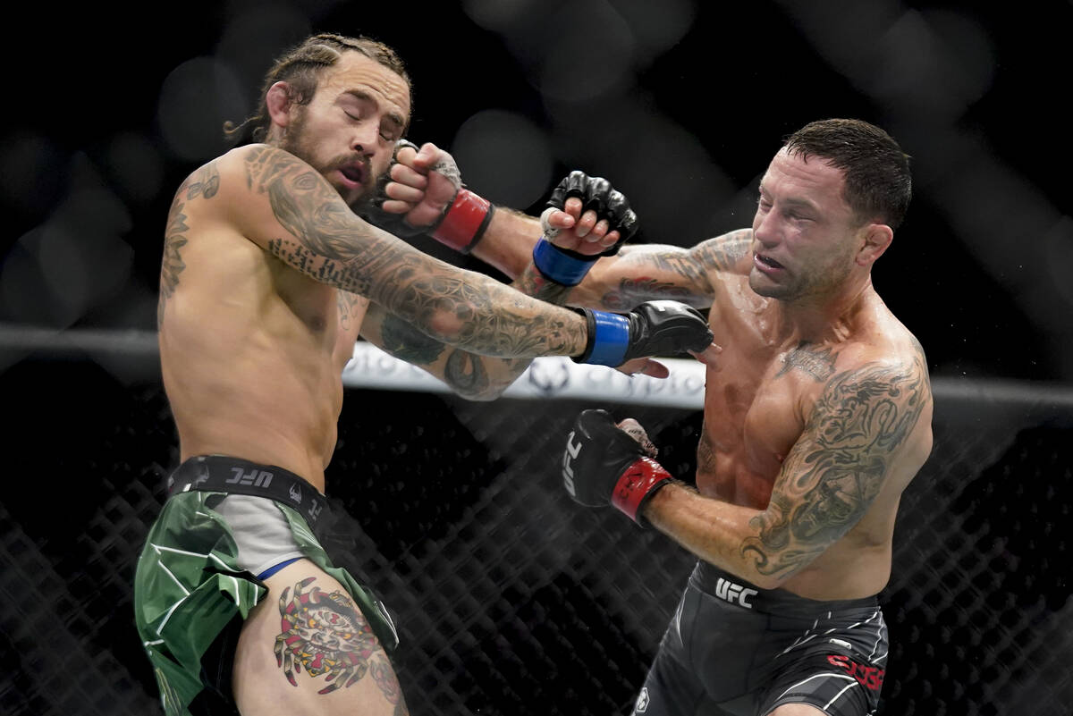 Marlon Vera, left, and Frankie Edgar exchange punches during a bantamweight mixed martial arts ...