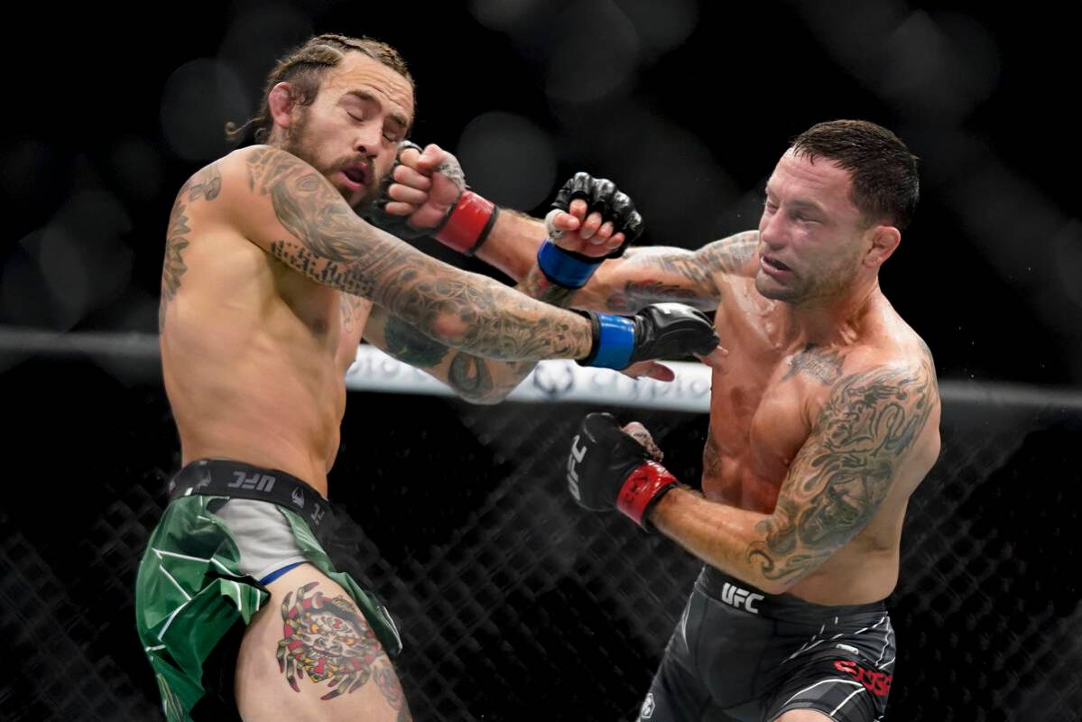 Marlon Vera, left, and Frankie Edgar exchange punches during a bantamweight mixed martial arts ...