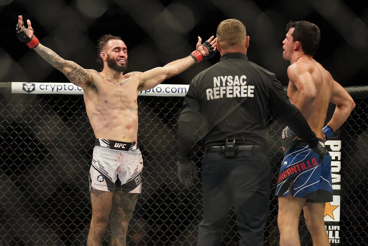 Shane Burgos, left, reacts after defeating Billy Quarantillo in a featherweight mixed martial a ...