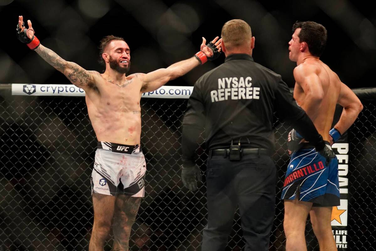 Shane Burgos, left, reacts after defeating Billy Quarantillo in a featherweight mixed martial a ...