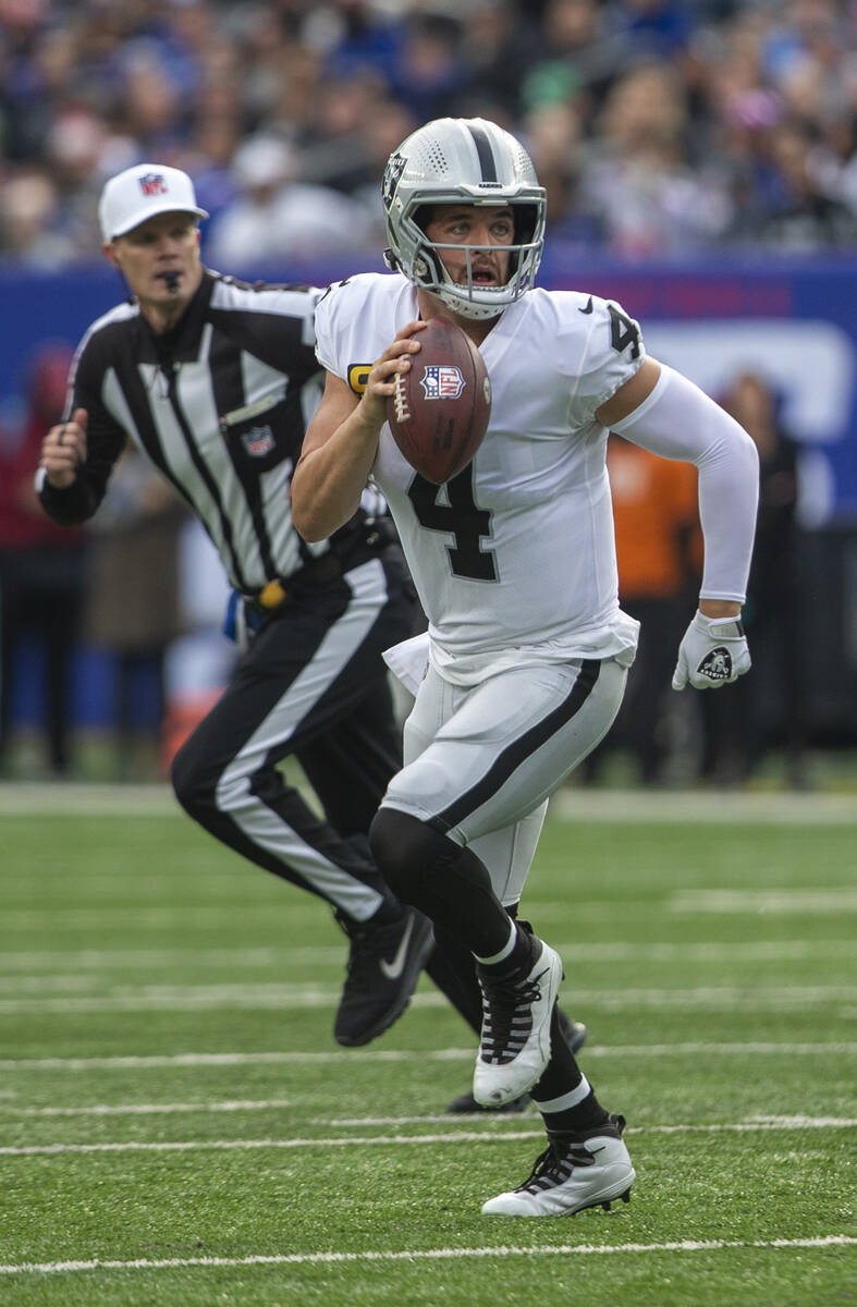 Las Vegas Raiders quarterback Derek Carr (4) looks for an open receiver as he is flushed out of ...