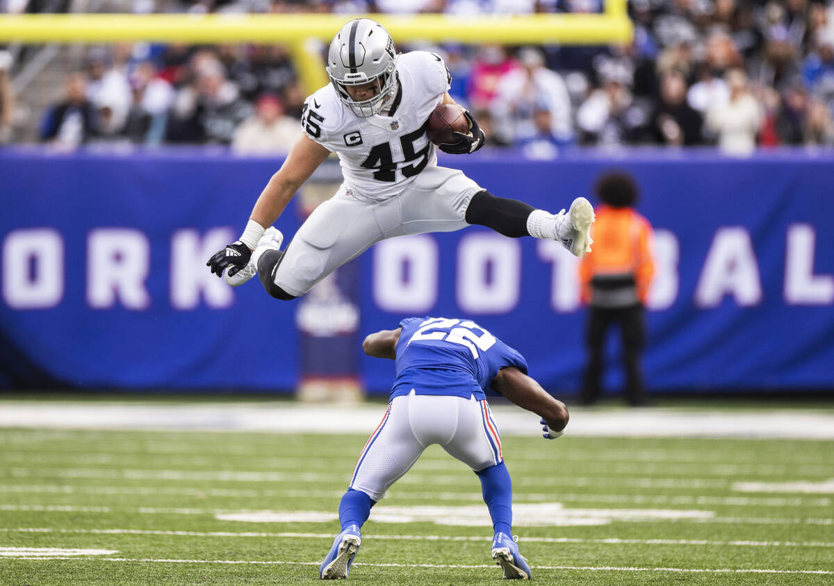 Las Vegas Raiders fullback Alec Ingold (45) leaps over New York Giants cornerback Adoree' Jacks ...