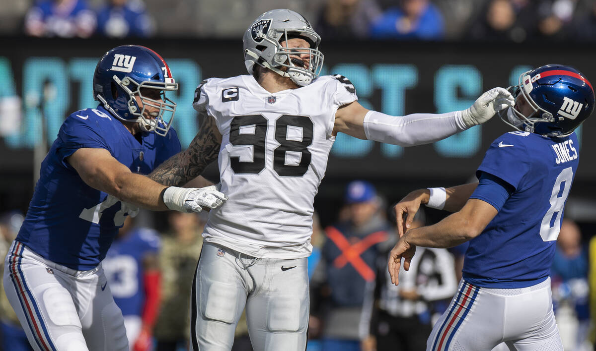 Las Vegas Raiders defensive end Maxx Crosby (98) gets a piece of New York Giants quarterback Da ...