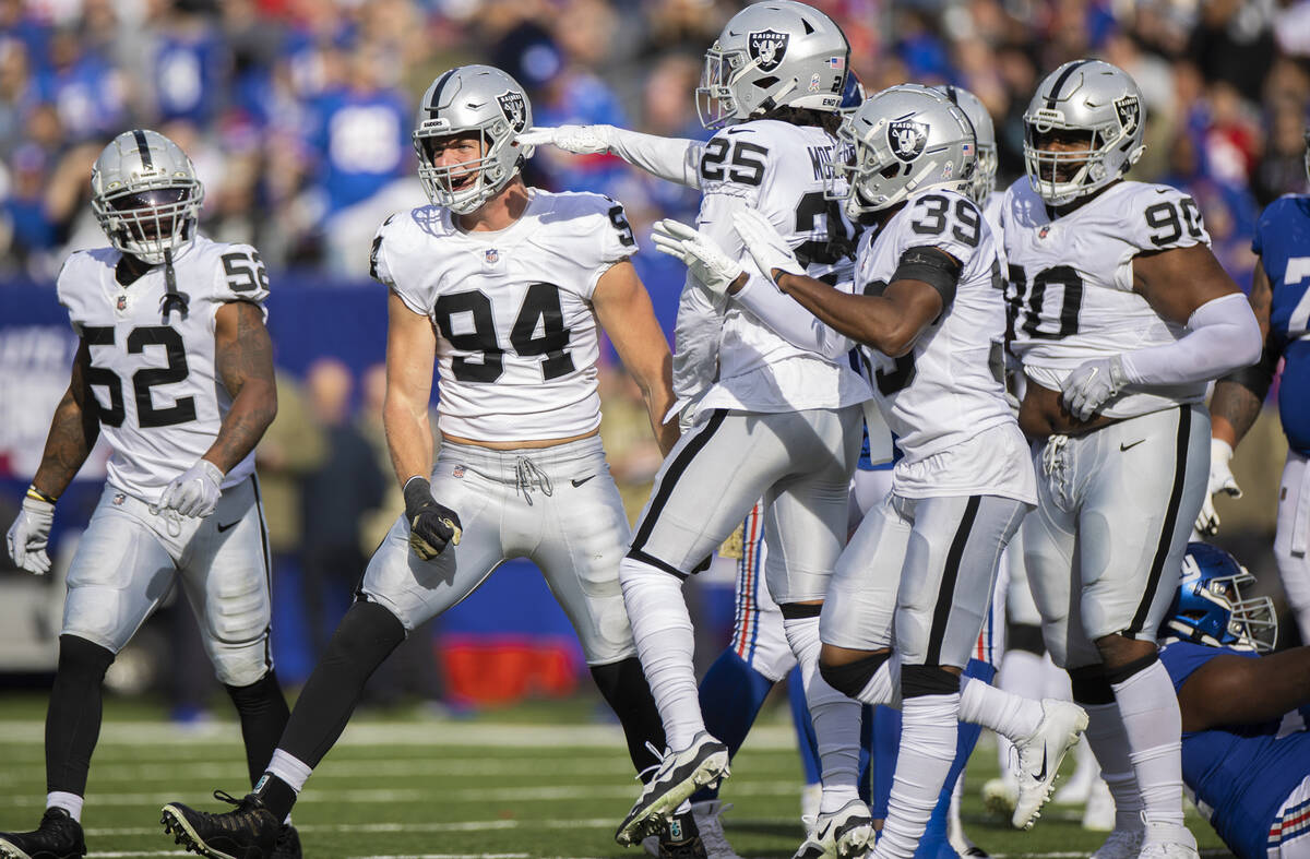 Las Vegas Raiders defensive end Carl Nassib (94) celebrates a big defensive play with teammates ...