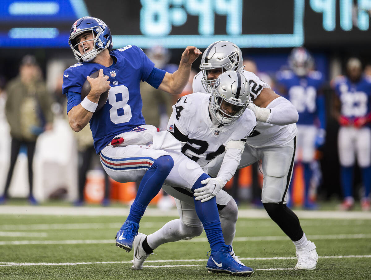 New York Giants quarterback Daniel Jones (8) is sacked by Las Vegas Raiders safety Johnathan Ab ...