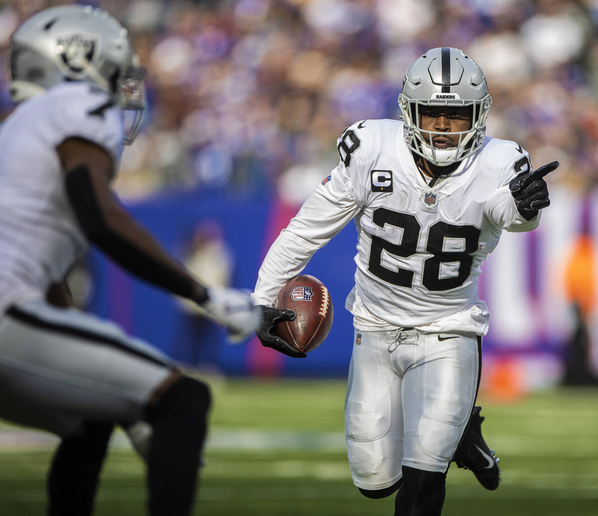 Las Vegas Raiders running back Josh Jacobs (28) asks for a block from Las Vegas Raiders wide re ...