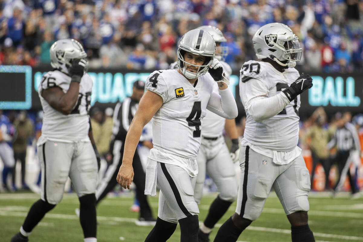 Las Vegas Raiders quarterback Derek Carr (4) looks dejected as he walks to the bench after thro ...