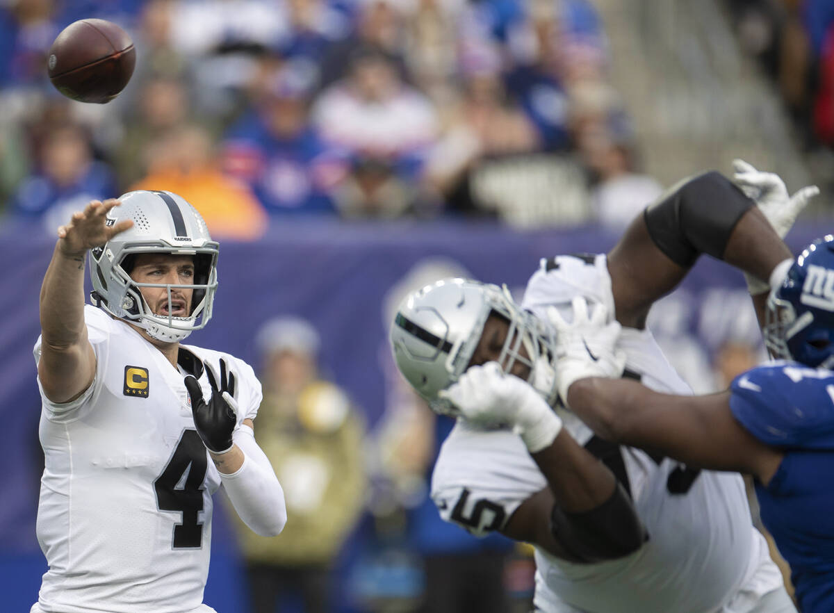 Las Vegas Raiders quarterback Derek Carr (4) makes a contested throw in the second half during ...