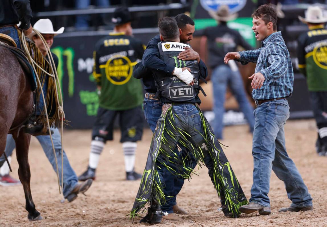 Jose Vitor Leme, facing away, celebrates after becoming the back-to-back PBR World Champion dur ...