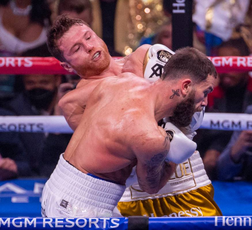 Saul "Canelo" Alvarez connects with the chin of Caleb Plant in the 1st round during t ...