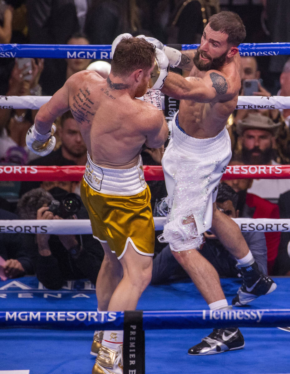 Caleb Plant, right, connects with the chin of Saul "Canelo" Alvarez in the 1st round ...