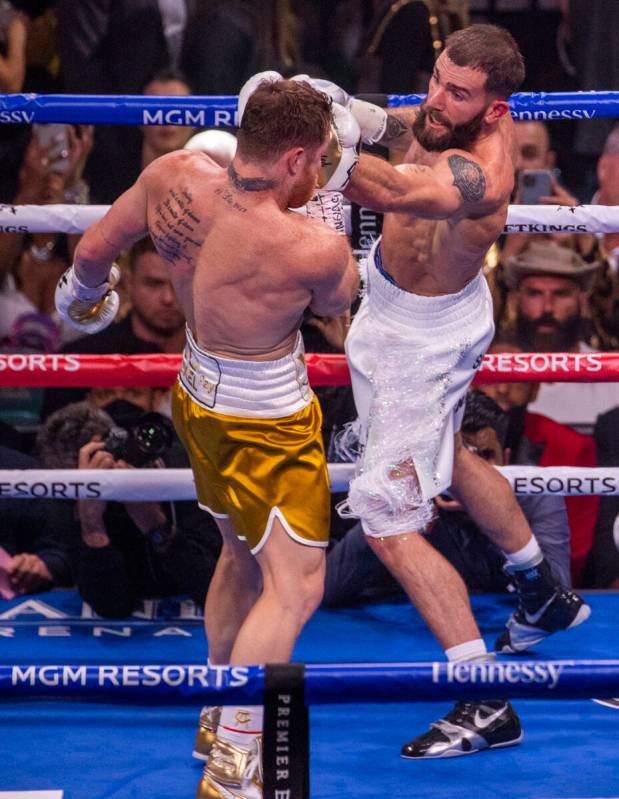 Caleb Plant, right, connects with the chin of Saul "Canelo" Alvarez in the 1st round ...