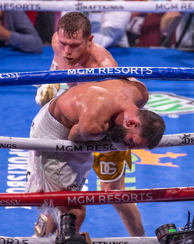 Saul "Canelo" Alvarez sends Caleb Plant through the ropes in the 10th round during th ...