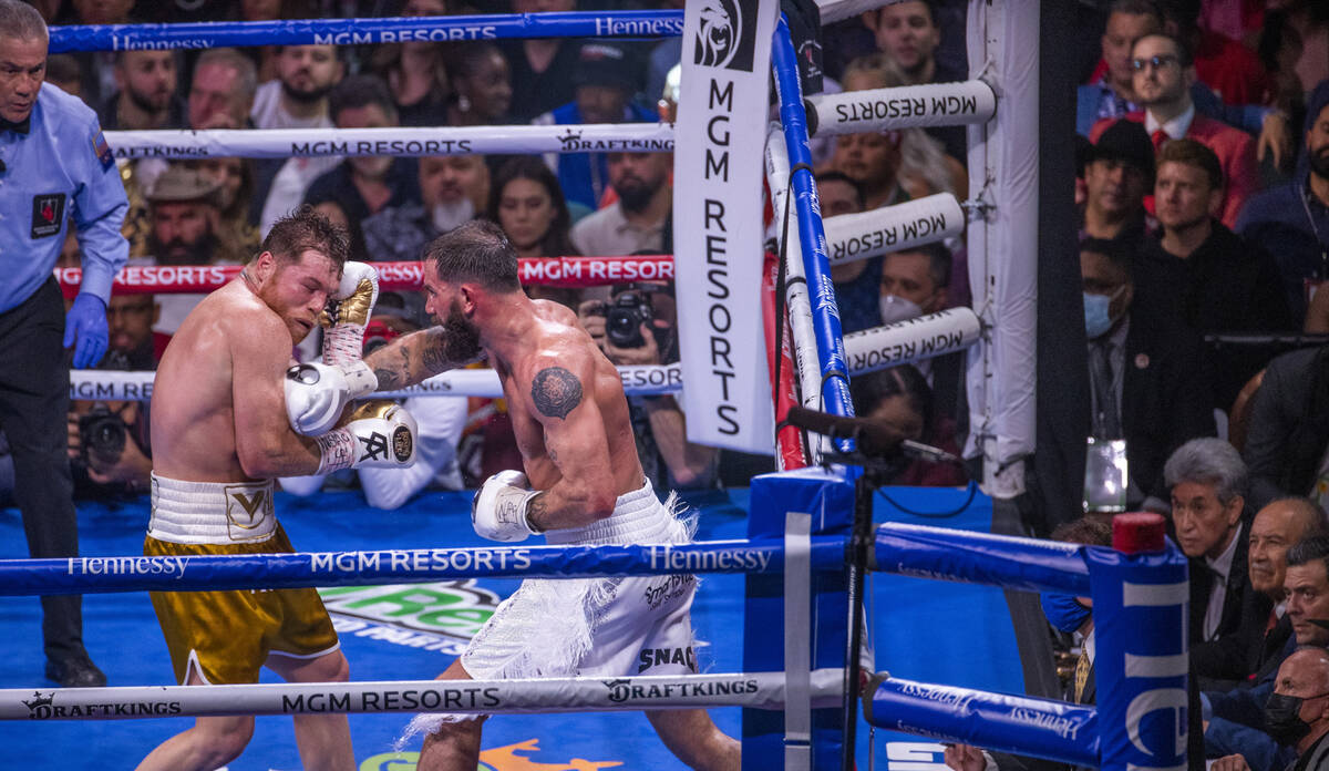 Saul "Canelo" Alvarez is hit by Caleb Plant in the 10th round during their super midd ...