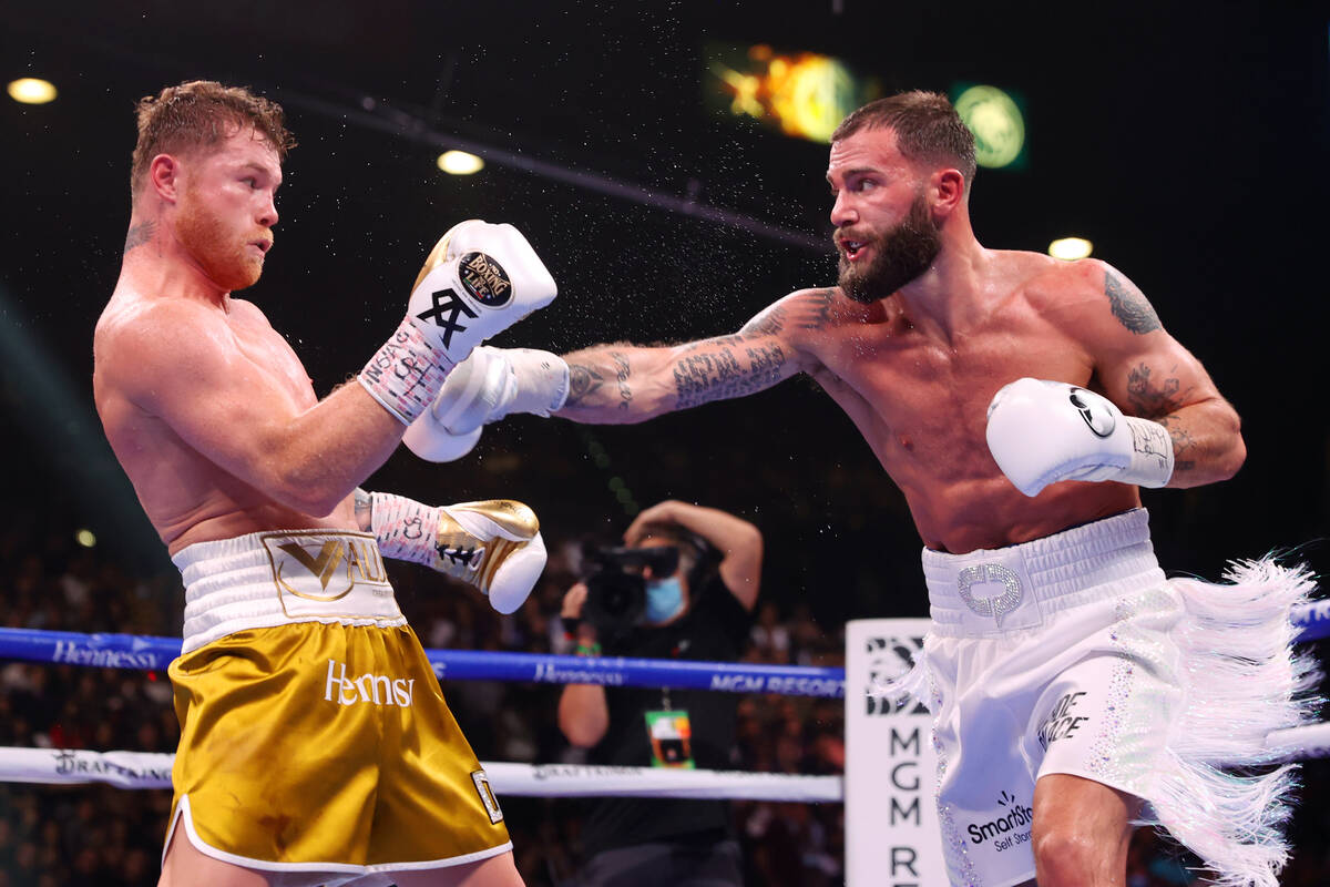 Saul “Canelo” Alvarez, left, moves away from a punch from Caleb Plant in the fift ...