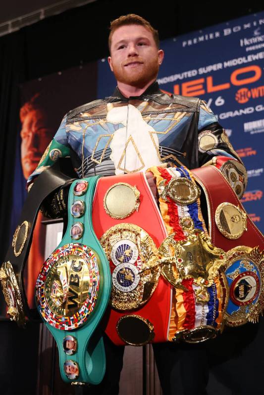 Saul ÒCaneloÓ Alvarez poses with all of his title belts following a press conference ...