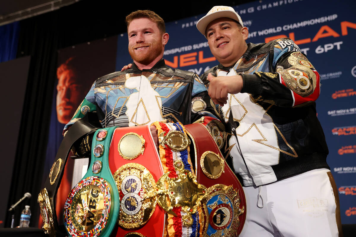 Saul ÒCaneloÓ Alvarez, left, with his trainer Eddy Reynoso, poses with all of his tit ...