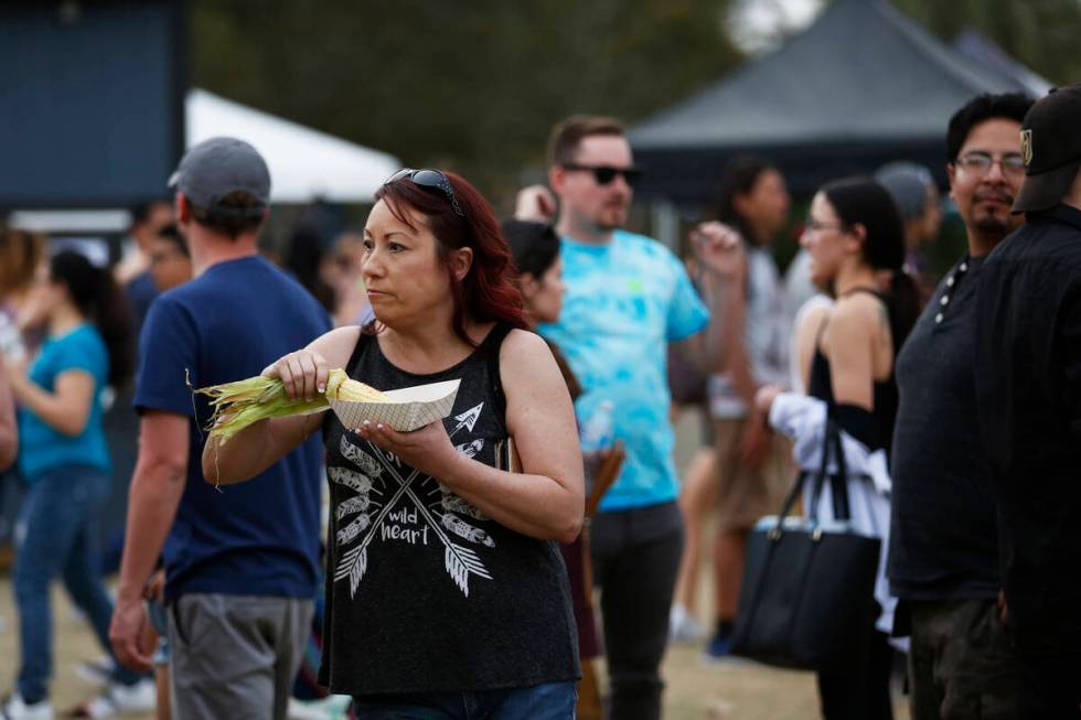 An attendee eats an elote during the first Tacos and Tamales Festival, organized by the Clark C ...