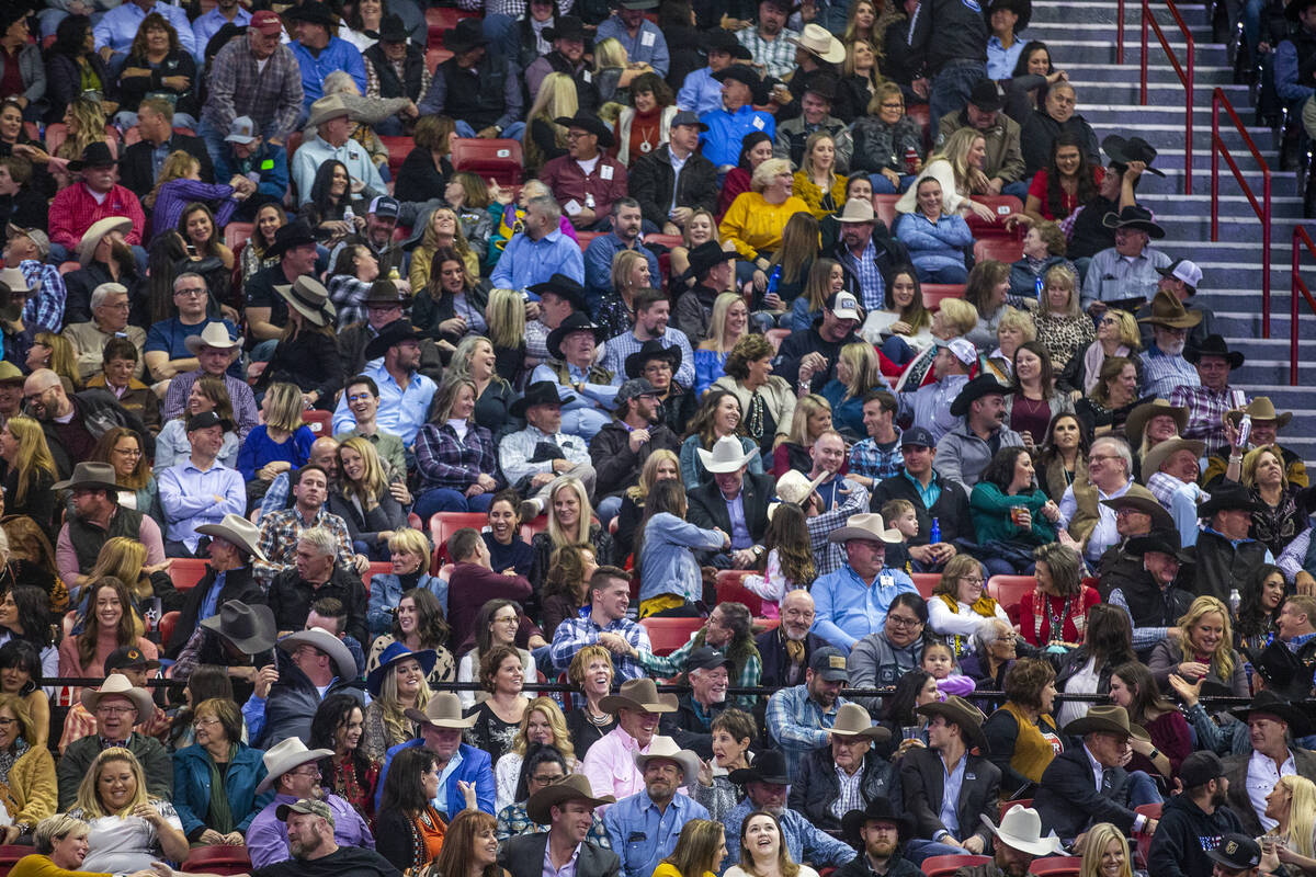 Fans greet their neighbors at the tenth go round of the Wrangler National Finals Rodeo at the T ...