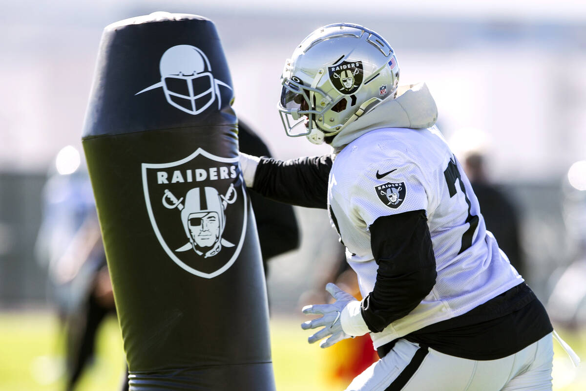 Raiders defensive tackle Quinton Jefferson (77) hits the tackle post during a practice session ...