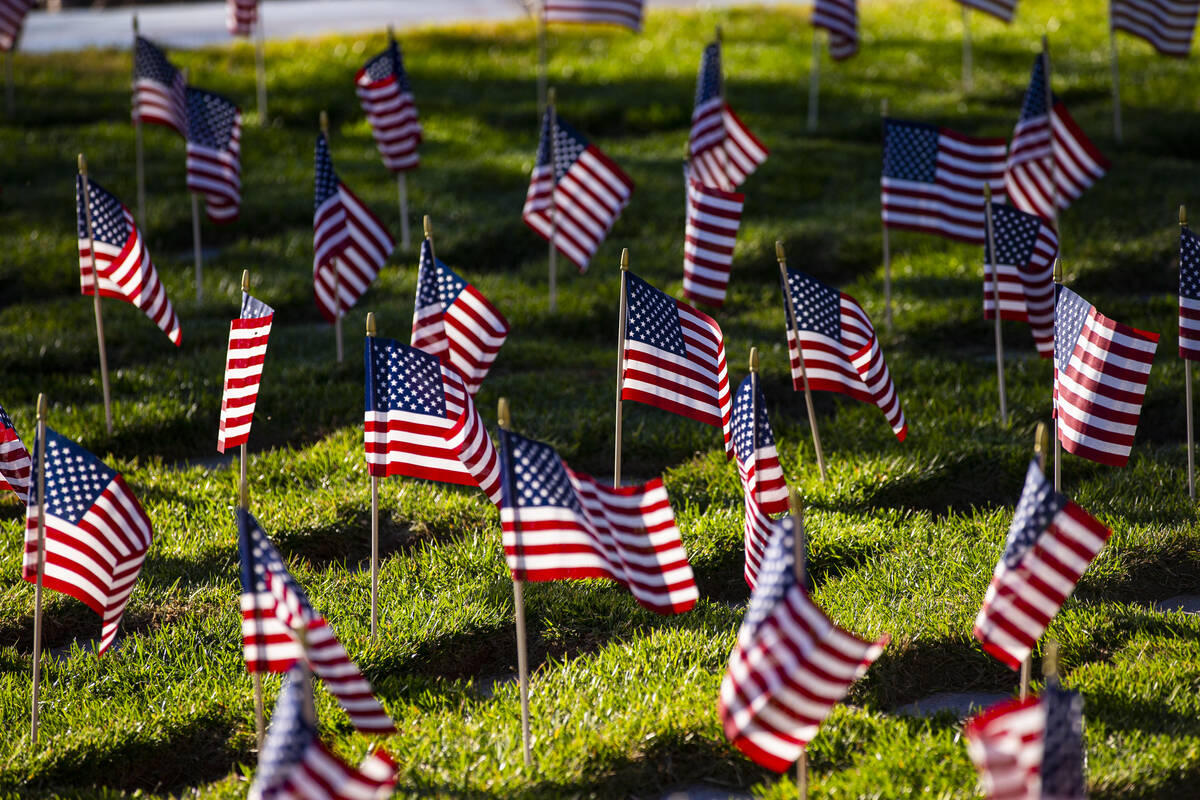 American flags are seen after being placed on graves by volunteers at the Southern Nevada Veter ...