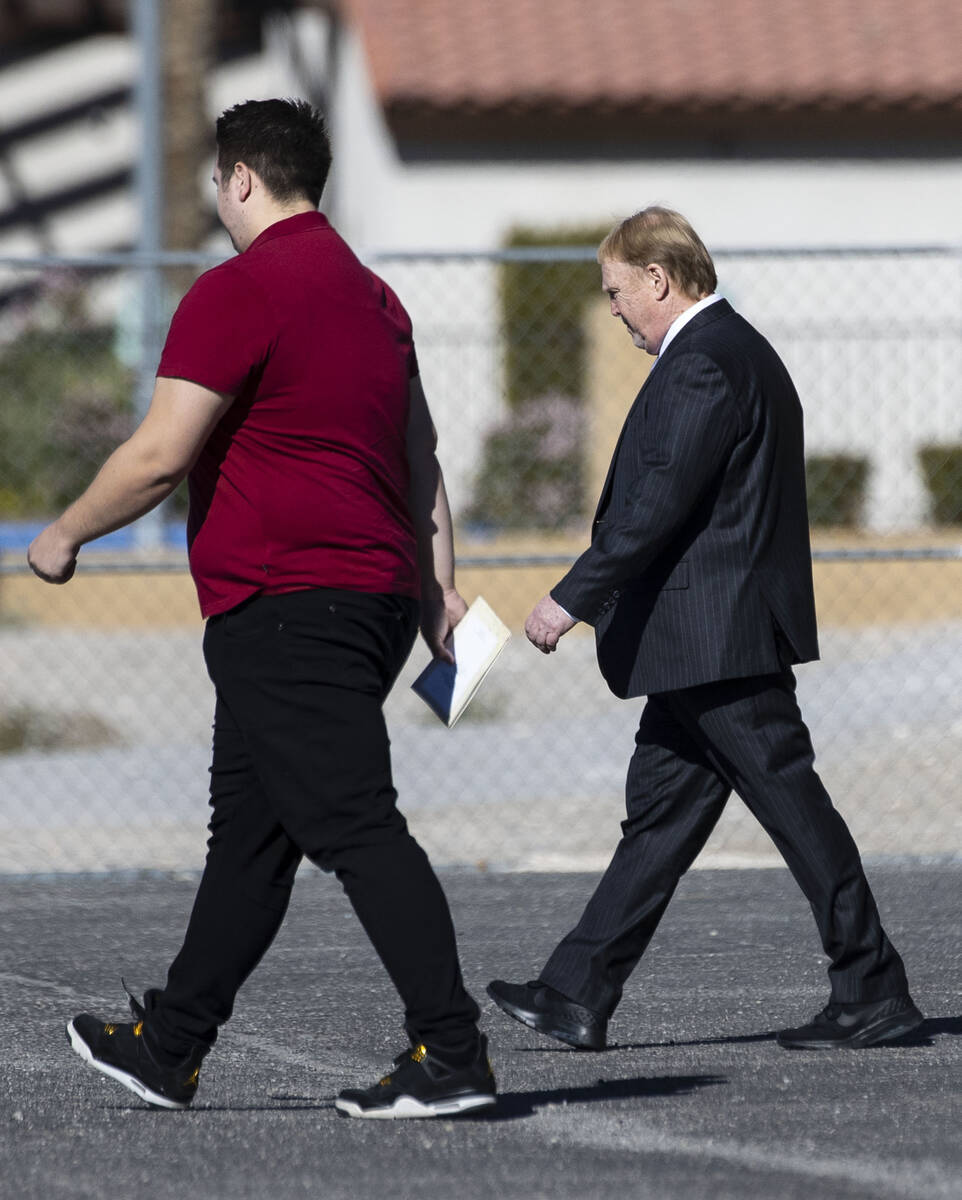 Raiders owner Mark Davis, right, leaves St. Simeon Serbian Orthodox Church after attending Tina ...