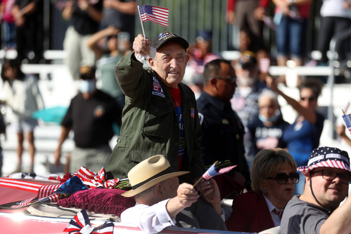 Onofrio "No-No" Zicari, a World War II veteran, waves at the crowd during the Veteran ...